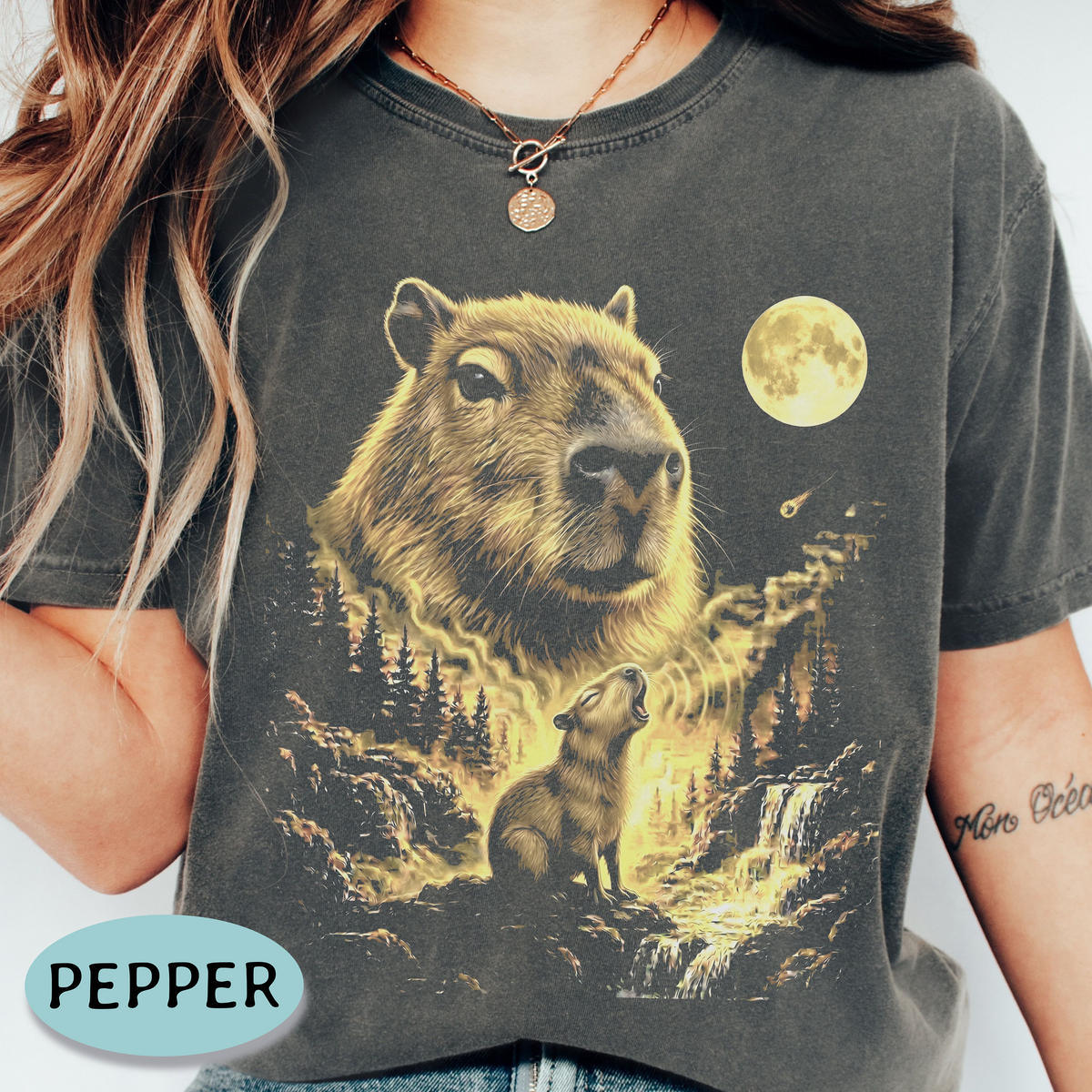 Capybara howling at the full moon in a golden forest on a Pepper Comfort Colors graphic shirt